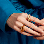Woman wearing two gold rings with citrine stone