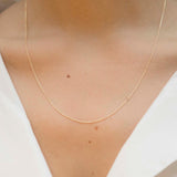 Yellow gold chain necklace with ring clasp worn by model
